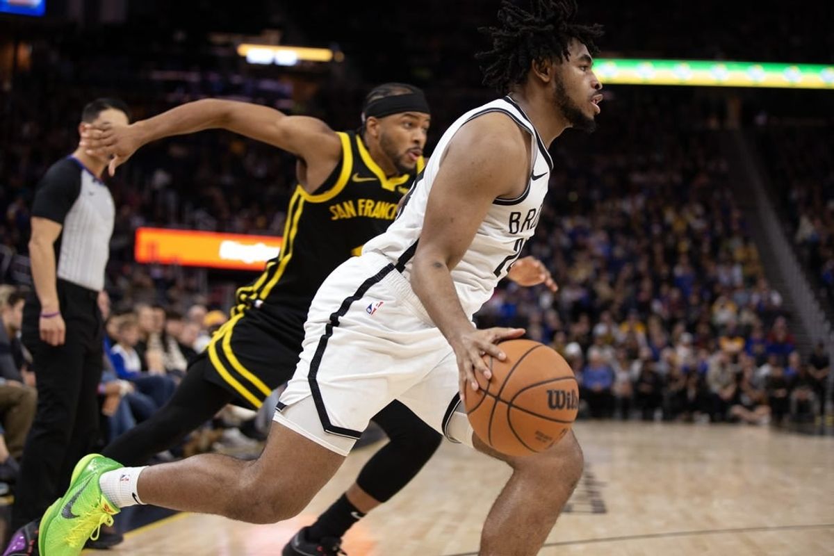 Dec 16, 2023; San Francisco, California, USA; Brooklyn Nets guard Cam Thomas (24) drives the baseline ahead of Golden State Warriors guard Moses Moody (4) during the third quarter at Chase Center.