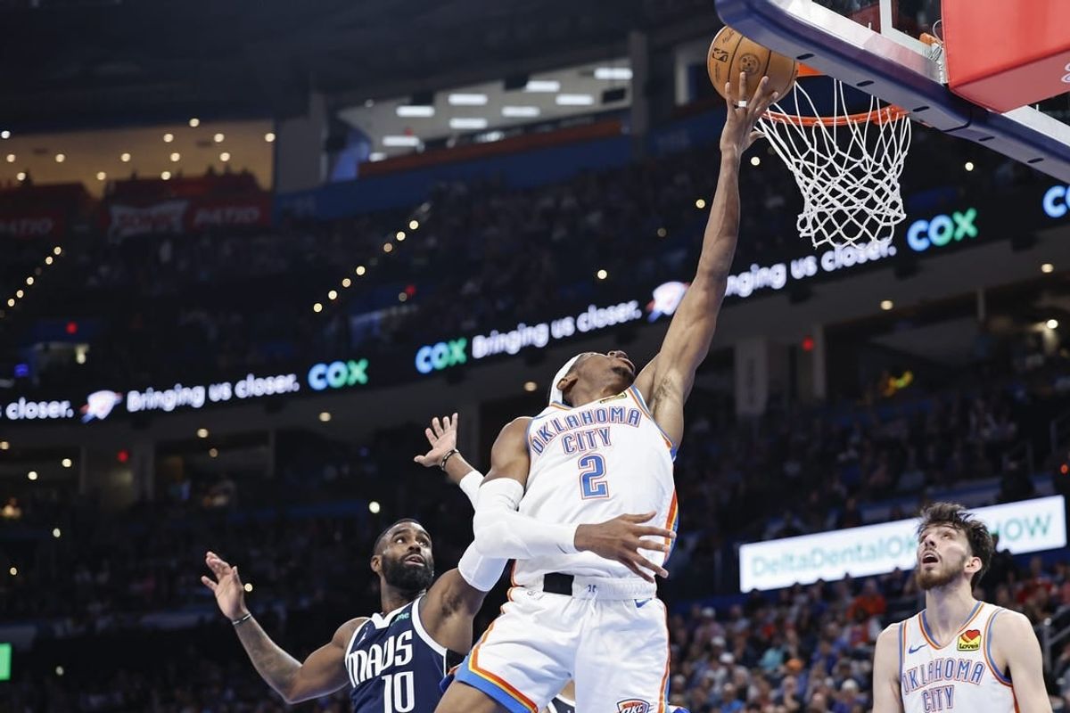 Mar 14, 2024; Oklahoma City, Oklahoma, USA; Oklahoma City Thunder guard Shai Gilgeous-Alexander (2) lays up a shot in front of Dallas Mavericks forward Tim Hardaway Jr. (10) during the second half at Paycom Center.