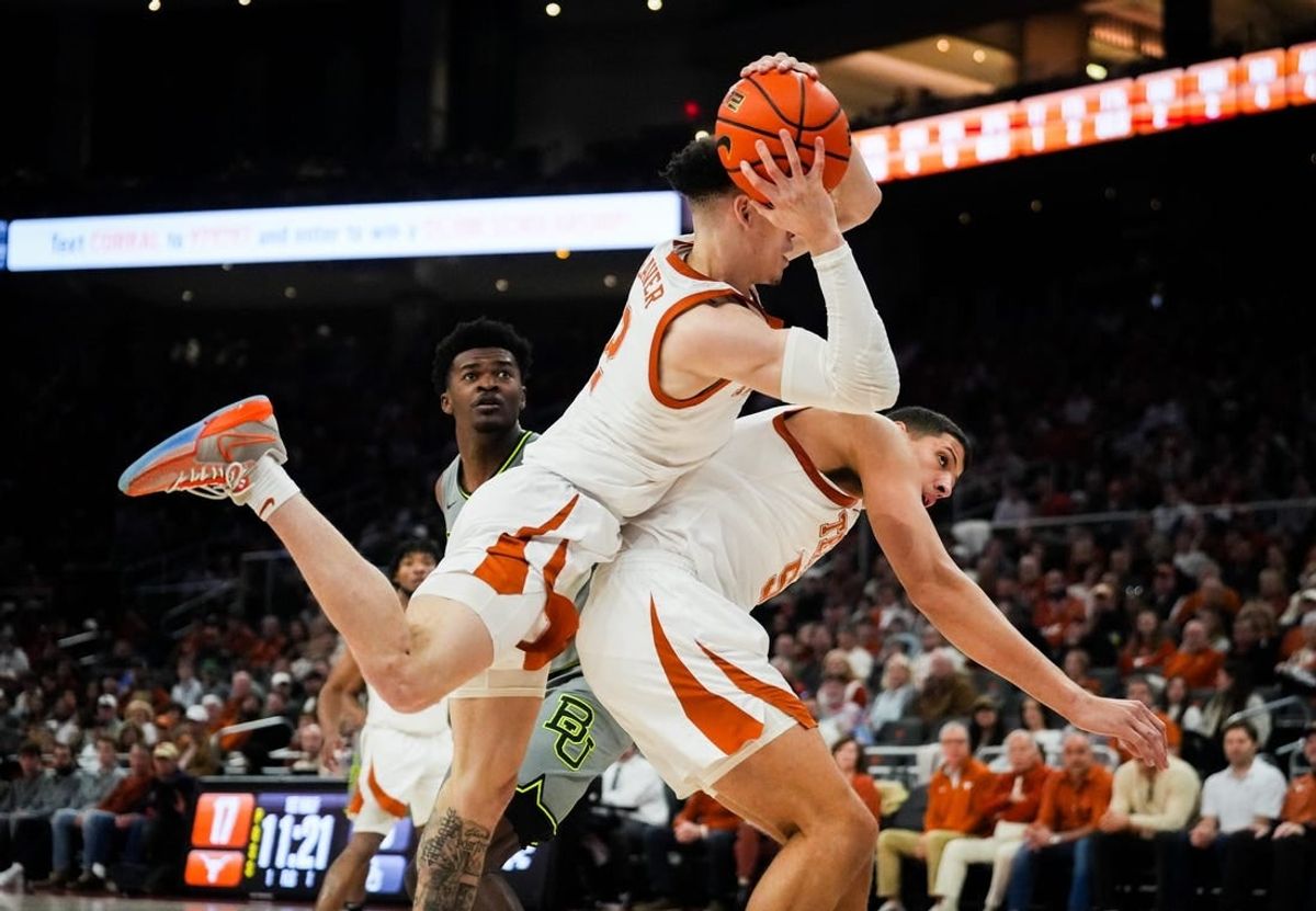Texas Longhorns guard Chendall Weaver (2) lands on top of forward Kadin Shedrick (5) after catching a defensive rebound in the first half of the Longhorns   game against the Baylor Bears at the Moody Center in Austin, Jan 20, 2024.