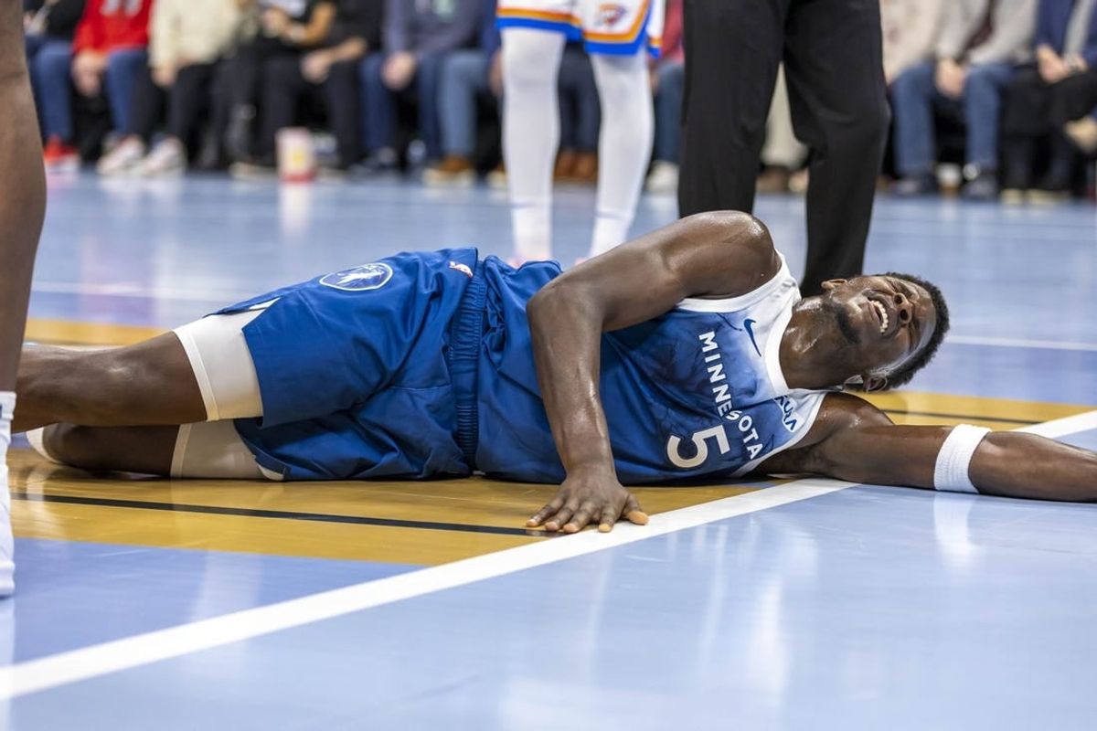 Nov 28, 2023; Minneapolis, Minnesota, USA; Minnesota Timberwolves guard Anthony Edwards (5) reacts after landing on the floor against the Oklahoma City Thunder in the second half at Target Center.