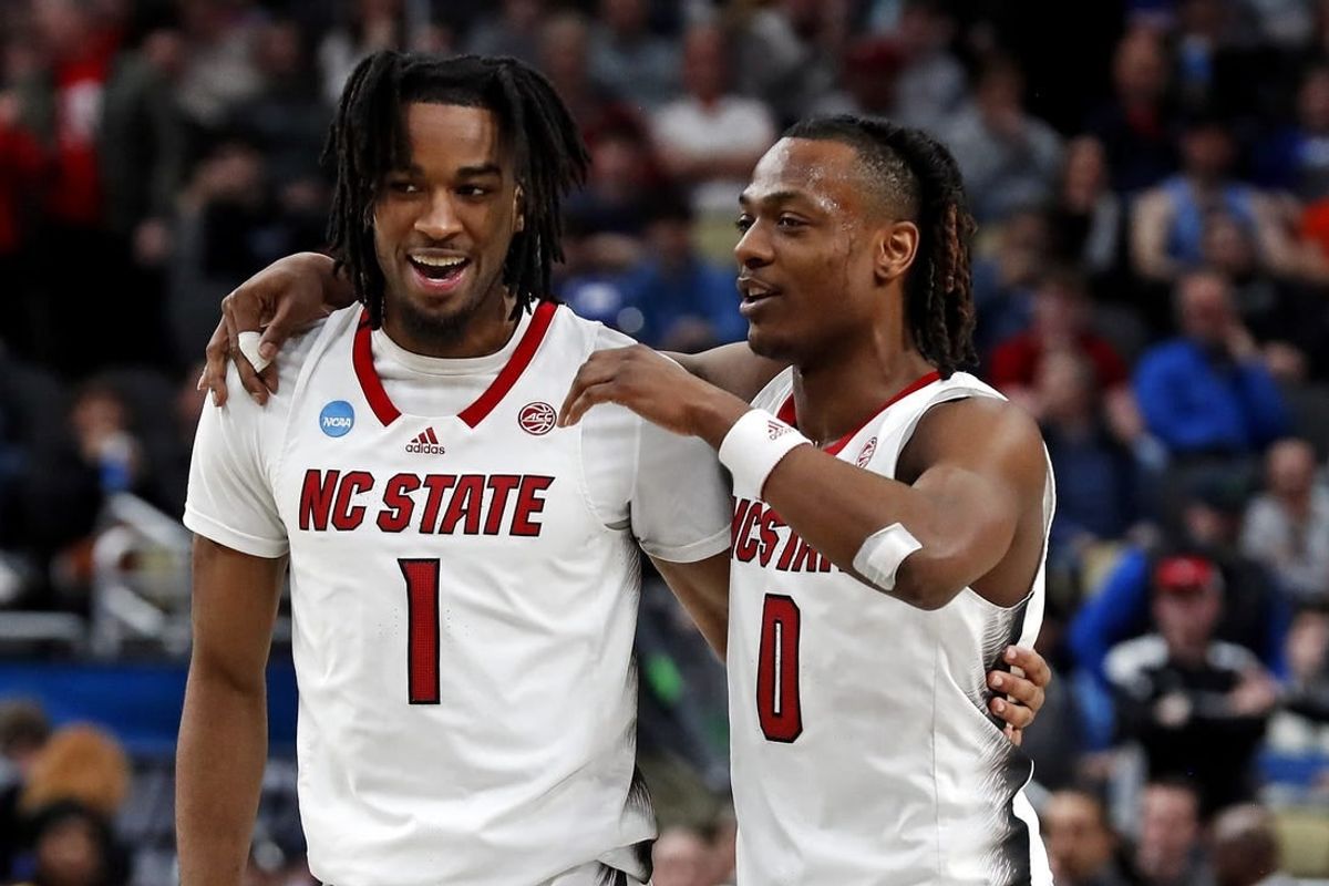 Mar 23, 2024; Pittsburgh, PA, USA; North Carolina State Wolfpack guard Jayden Taylor (1) celebrates with guard DJ Horne (0) after beating the Oakland Golden Grizzlies in the second round of the 2024 NCAA Tournament at PPG Paints Arena.