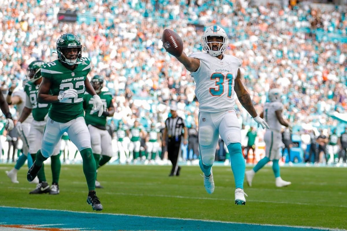 Dec 17, 2023; Miami Gardens, Florida, USA; Miami Dolphins running back Raheem Mostert (31) runs the football for a touchdown against the New York Jets during the first quarter at Hard Rock Stadium.