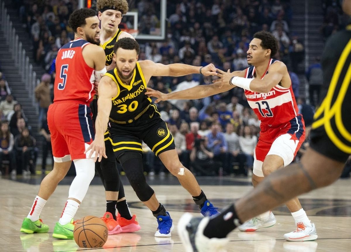 Dec 22, 2023; San Francisco, California, USA; Golden State Warriors guard Stephen Curry (30) dribbles away from pressure by Washington Wizards guard Jordan Poole (13) during the first quarter at Chase Center.
