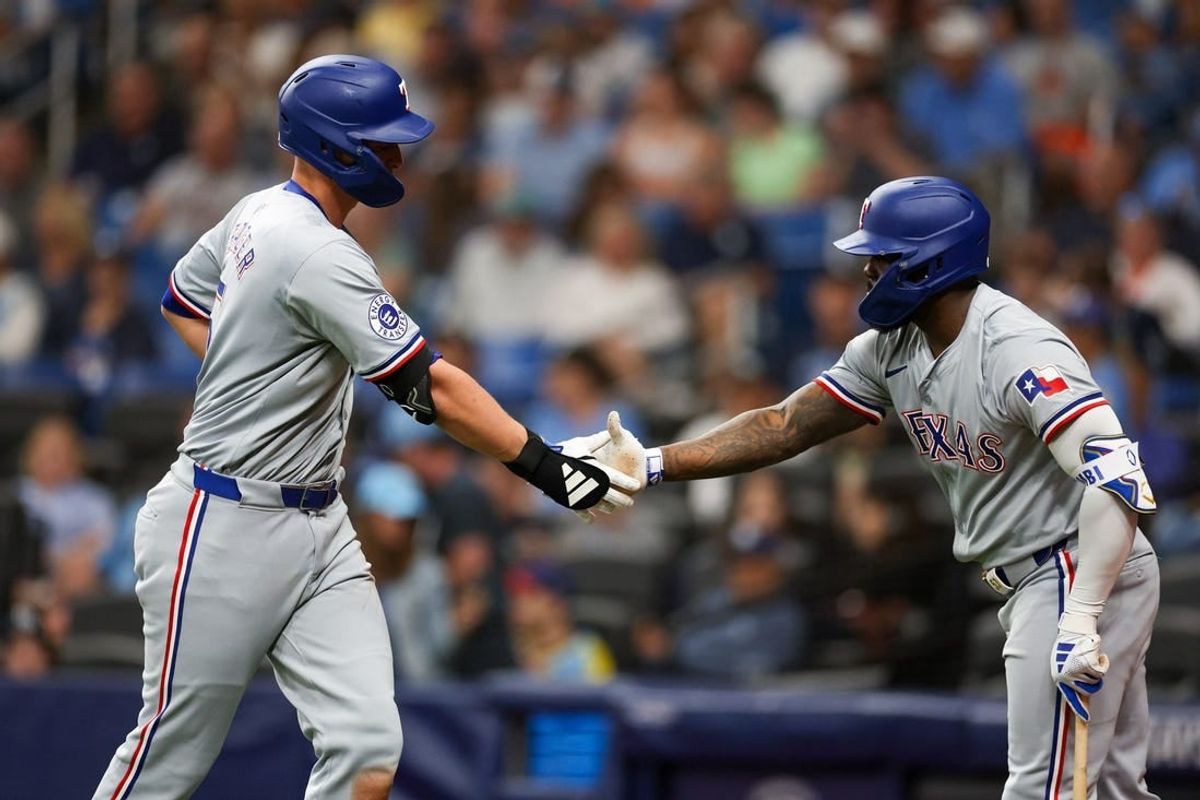 Apr 3, 2024; St. Petersburg, Florida, USA;  Texas Rangers right fielder Adolis Garcia (53) congratulates designated hitter Corey Seager (5) after hitting a home run against the Tampa Bay Rays in the sixth inning at Tropicana Field.