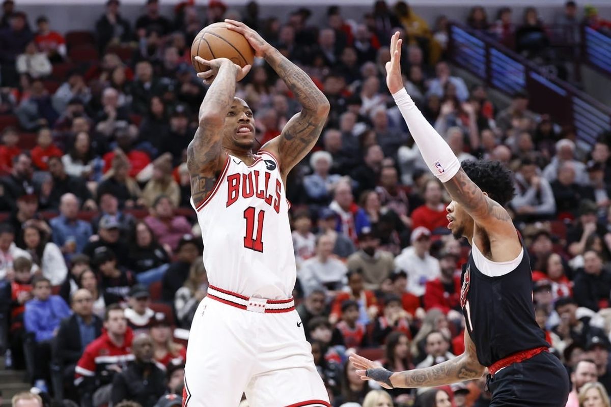 Mar 18, 2024; Chicago, Illinois, USA; Chicago Bulls forward DeMar DeRozan (11) shoots against Portland Trail Blazers guard Anfernee Simons (1) during the first half at United Center.