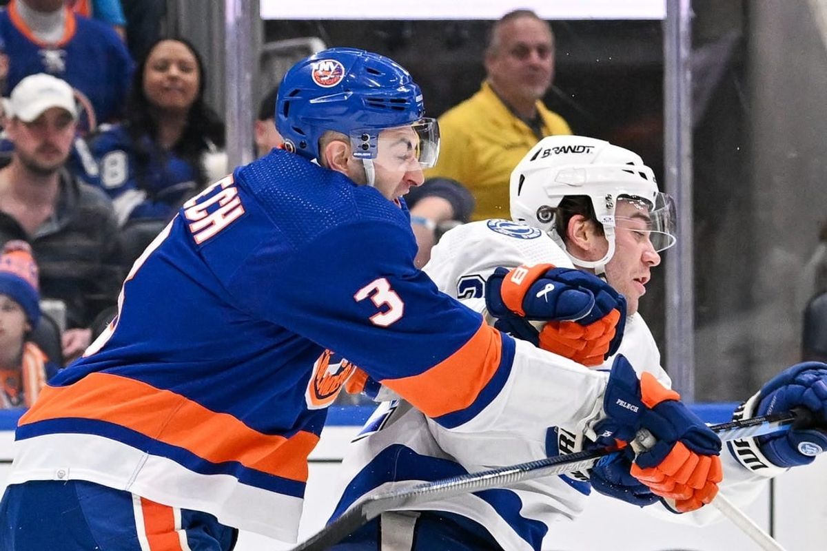 Feb 8, 2024; Elmont, New York, USA; New York Islanders defenseman Adam Pelech (3) checks Tampa Bay Lightning center Brayden Point (21) during the first period at UBS Arena.