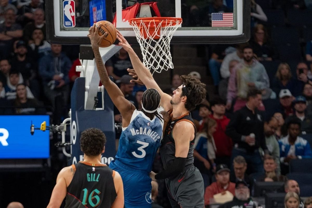 Apr 9, 2024; Minneapolis, Minnesota, USA; Minnesota Timberwolves forward Jaden McDaniels (3) has a shot blocked by Washington Wizards forward Deni Avdija (8) in the first quarter at Target Center.