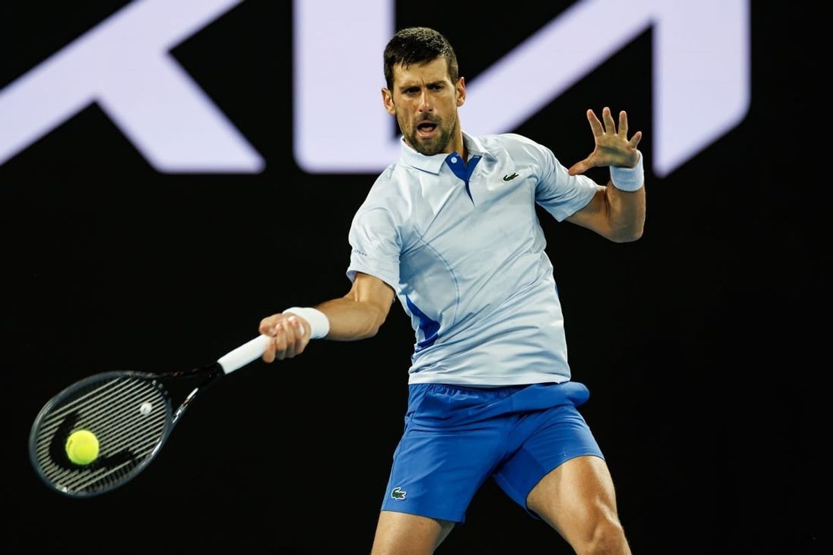 Jan 14, 2024; Melbourne, Victoria, Australia;  Novak Djokovic of Serbia hits a shot against Dino Prizmic of Croatia in the first round of the men   s singles.