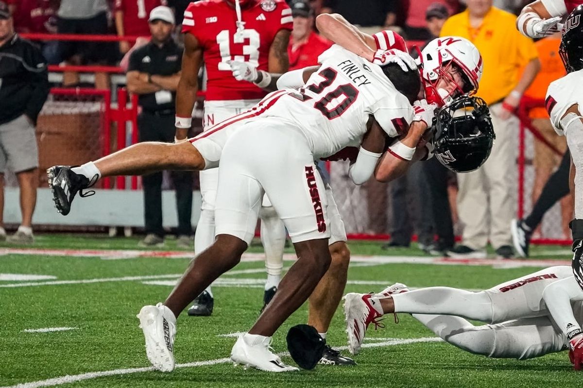 Sep 16, 2023; Lincoln, Nebraska, USA; Northern Illinois Huskies cornerback Jacob Finley (20) loses his helmet while tackling Nebraska Cornhuskers wide receiver Alex Bullock (84) during the third quarter at Memorial Stadium.