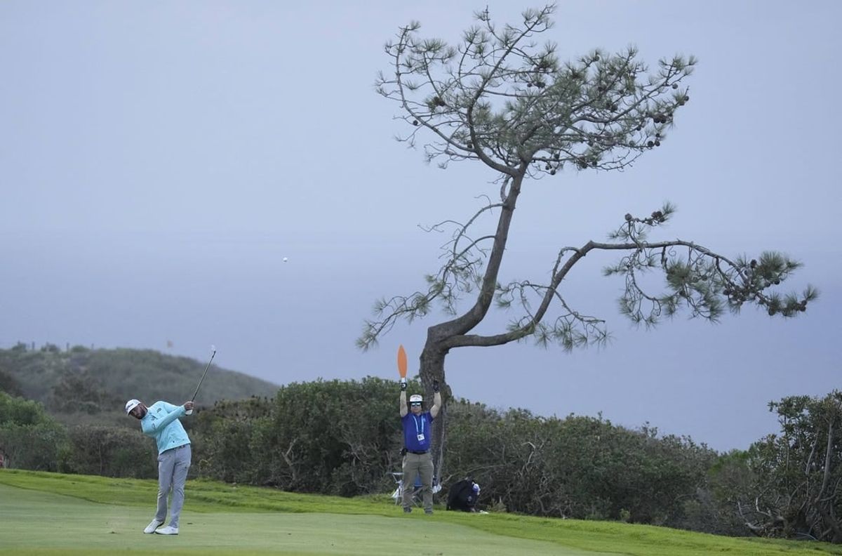 Jan 28, 2023; San Diego, California, USA; Max Homa  plays his shot on the seventeenth hole during the final round of the Farmers Insurance Open golf tournament at Torrey Pines Municipal Golf Course - South Course.