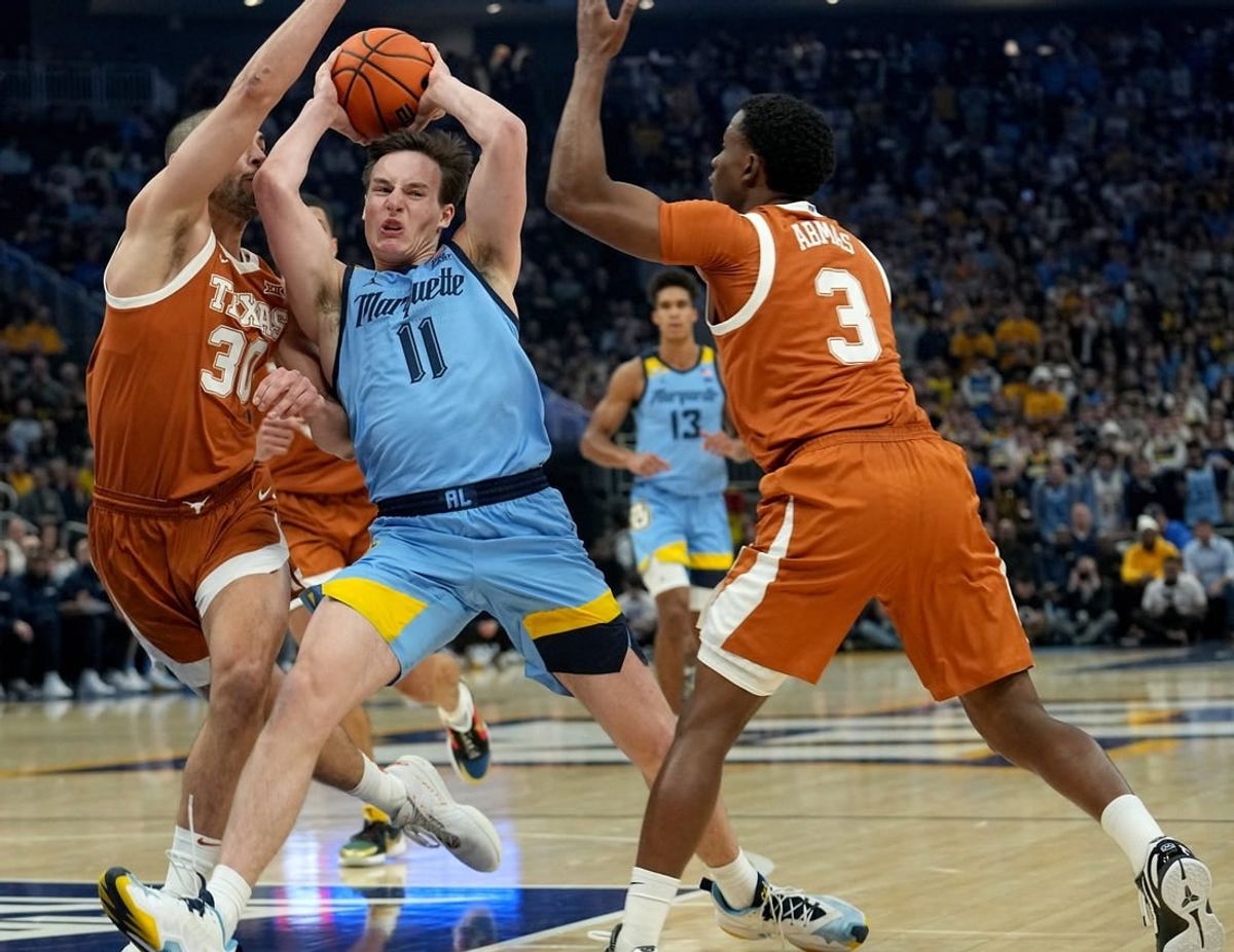 Marquette guard Tyler Kolek (11) is double-teamed b y Texas forward Brock Cunningham (30) and guard Max Abmas (3) during the first half of their game Wednesday, December 6, 2023 at Fiserv Forum in Milwaukee, Wisconsin.