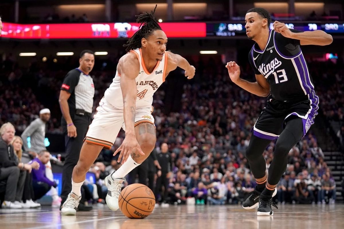 Mar 7, 2024; Sacramento, California, USA; San Antonio Spurs guard Devin Vassell (24) dribbles past Sacramento Kings forward Keegan Murray (13) in the third quarter at the Golden 1 Center.