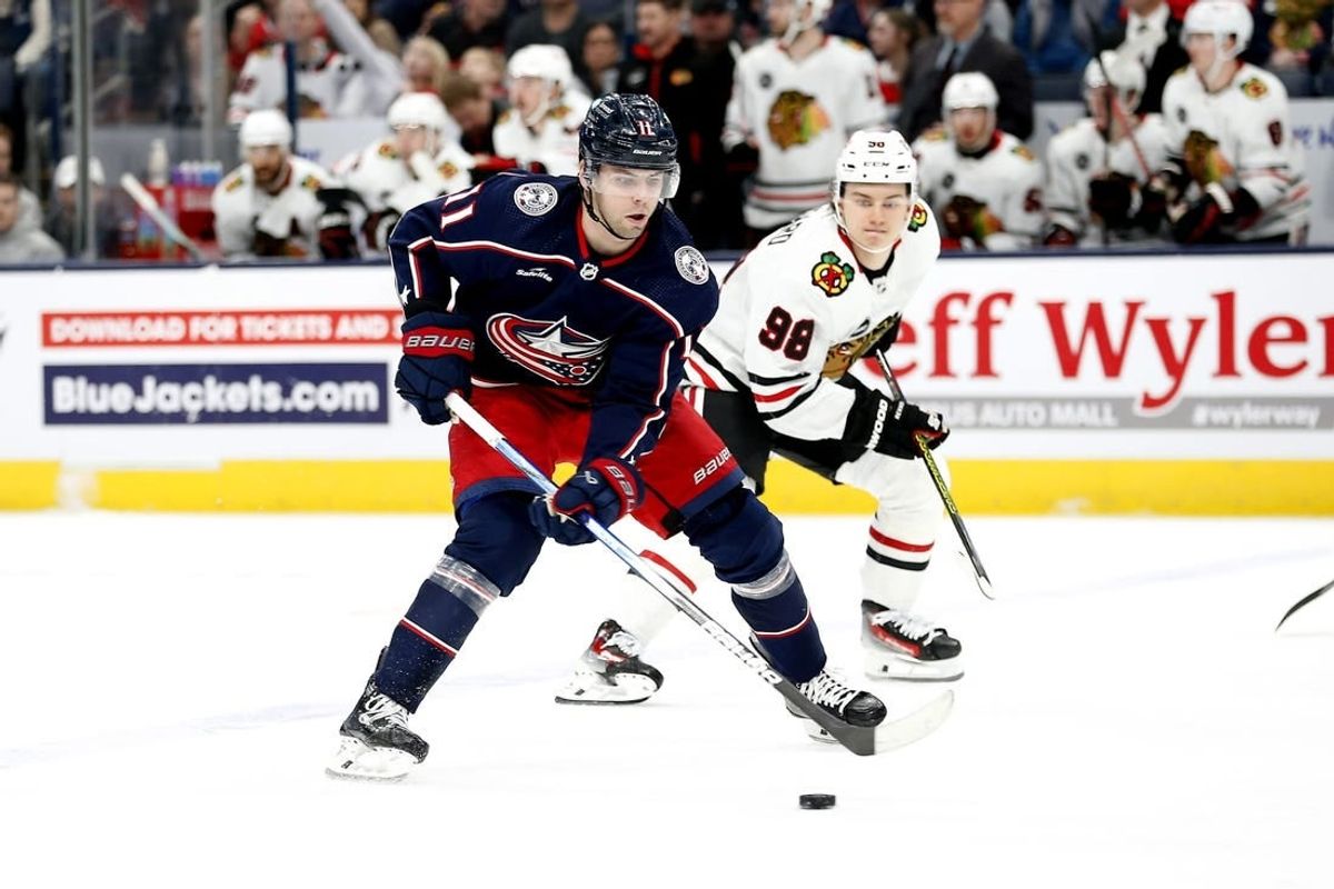 Nov 22, 2023; Columbus, Ohio, USA; Columbus Blue Jackets center Adam Fantilli (11) shoots the puck as Chicago Blackhawks center Connor Bedard (98) trails the play during the first period at Nationwide Arena.