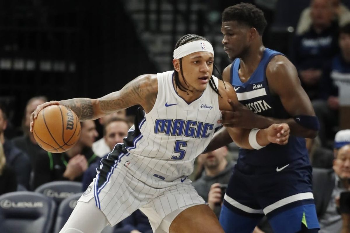 Feb 2, 2024; Minneapolis, Minnesota, USA; Orlando Magic forward Paolo Banchero (5) works around Minnesota Timberwolves guard Anthony Edwards (5) in the first quarter at Target Center.