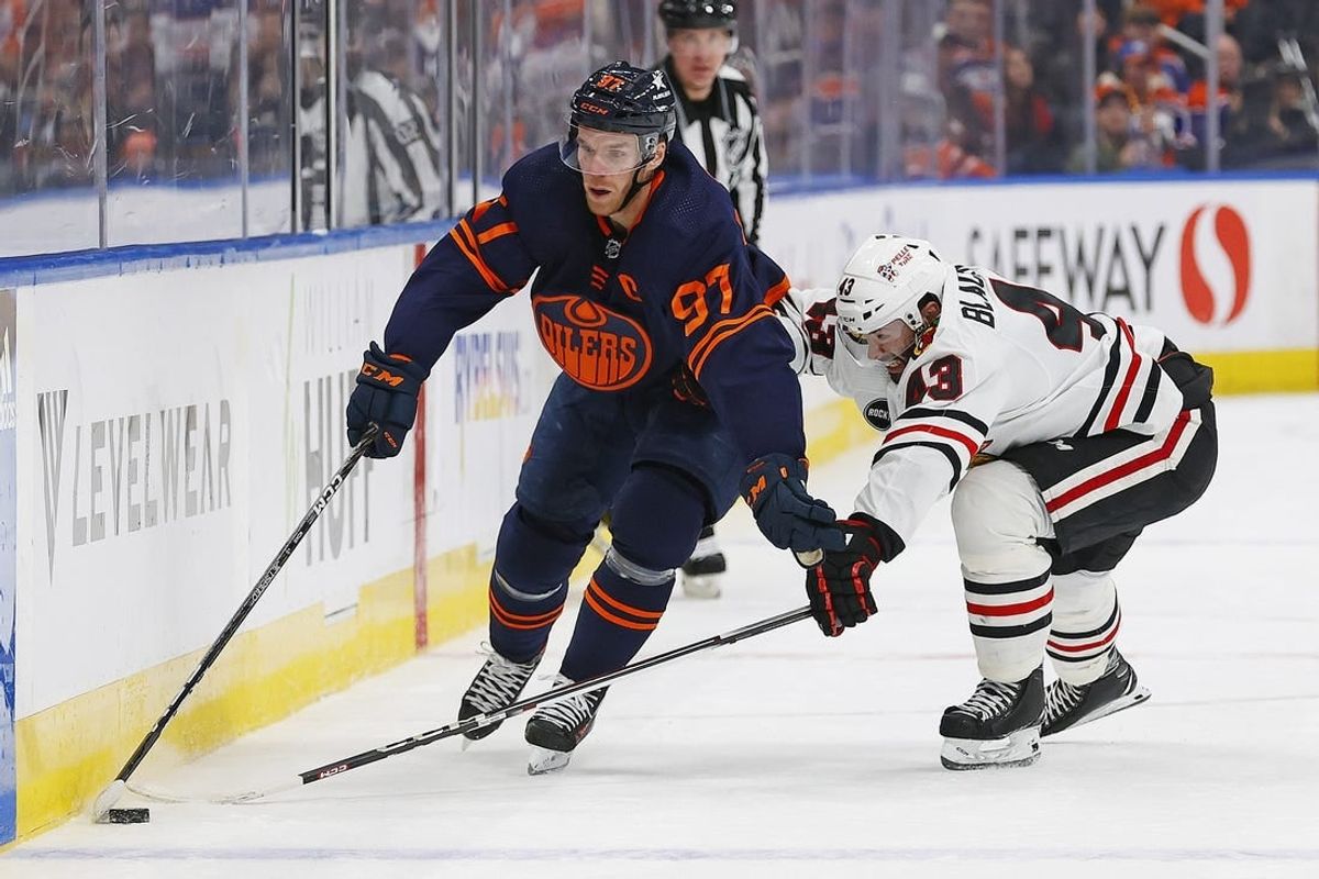 Jan 25, 2024; Edmonton, Alberta, CAN; Edmonton Oilers forward Connor McDavid (97) carries the puck around Chicago Blackhawks forward Colin Blackwell (43) during the first period at Rogers Place.