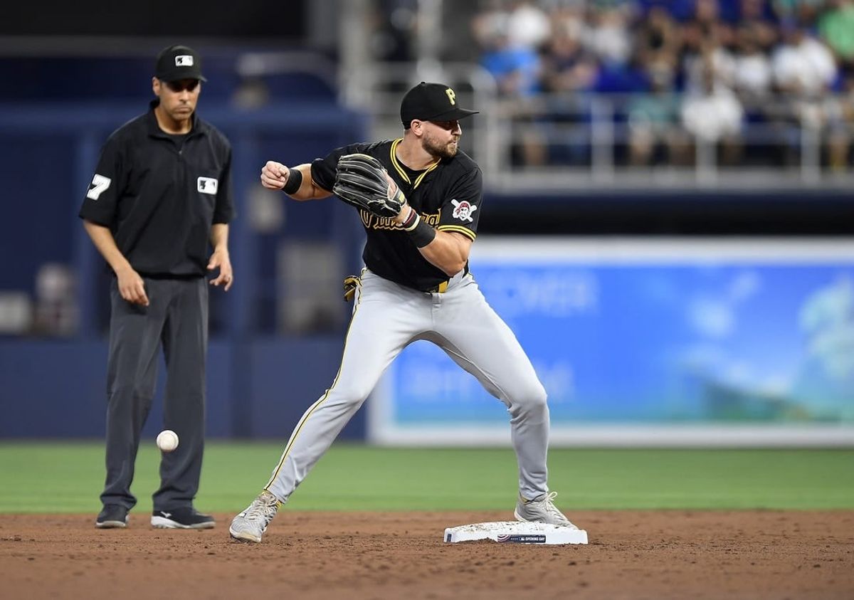 Mar 28, 2024; Miami, Florida, USA;  Pittsburgh Pirates second baseman Jared Triolo drops the ball while trying to turn a double play during the second inning against the Miami Marlins, at loanDepot Park.