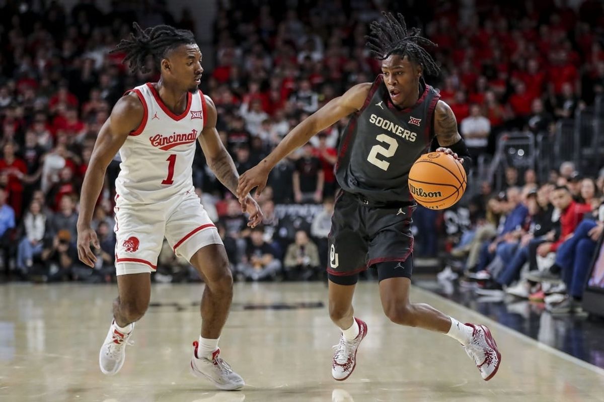 Jan 20, 2024; Cincinnati, Ohio, USA; Oklahoma Sooners guard Javian McCollum (2) dribbles against Cincinnati Bearcats guard Day Day Thomas (1) in the first half at Fifth Third Arena.
