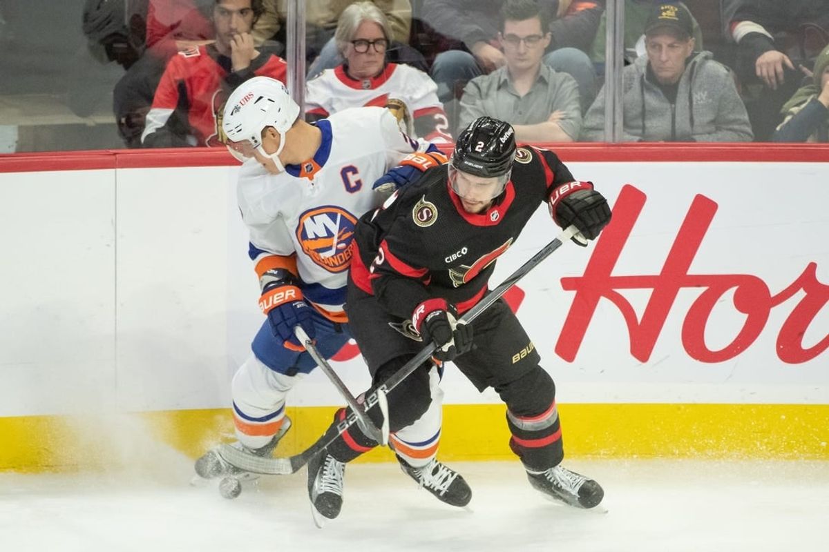 Nov 24 2023; Ottawa, Ontario, CAN; New York Islanders left wing Anders Lee (27) battles with Ottawa Senators defenseman Artem Zub (2) in the third period at the Canadian Tire Centre.