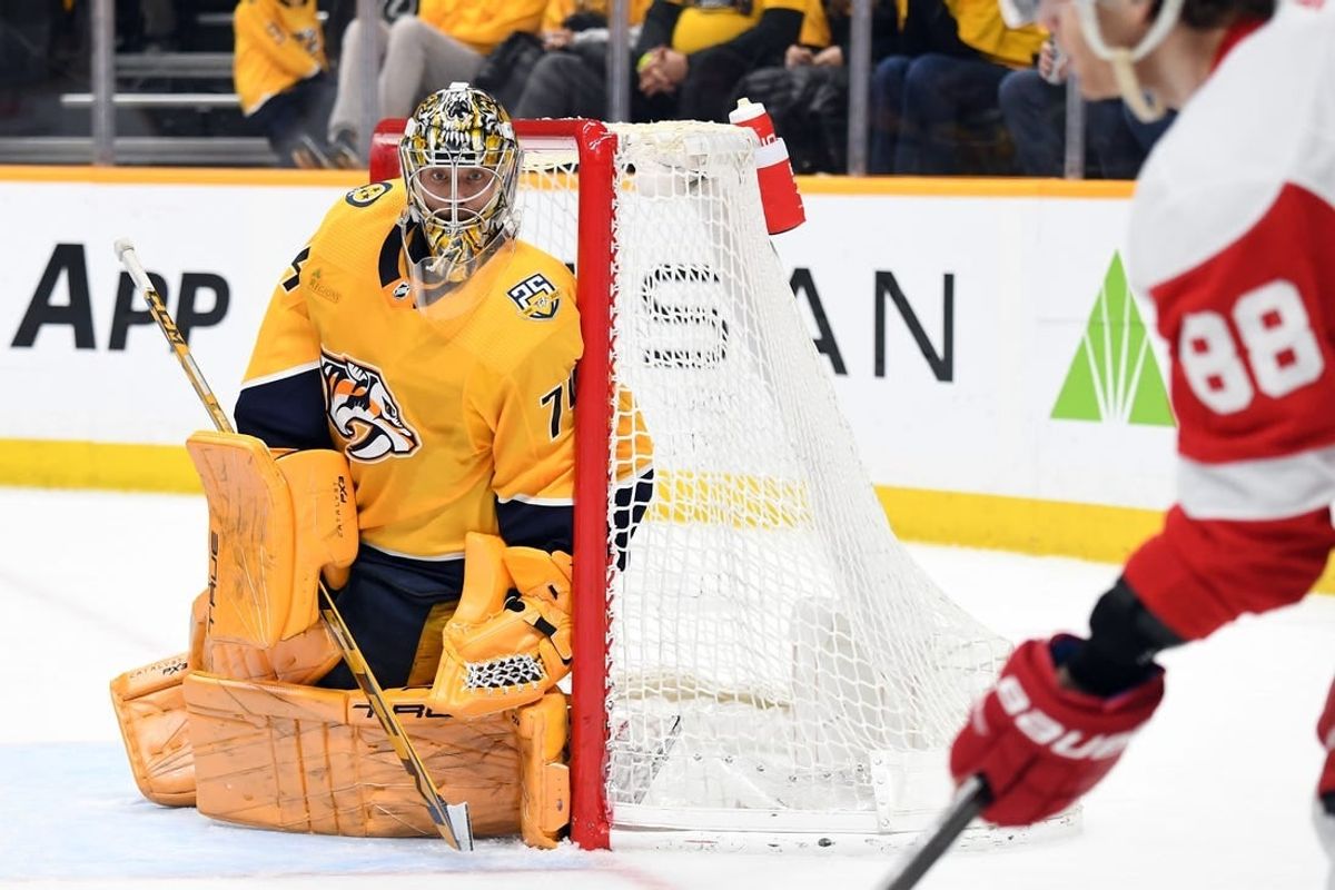 Mar 23, 2024; Nashville, Tennessee, USA; Nashville Predators goaltender Juuse Saros (74) watches as Detroit Red Wings right wing Patrick Kane (88) handles the puck in the corner during the second period at Bridgestone Arena.