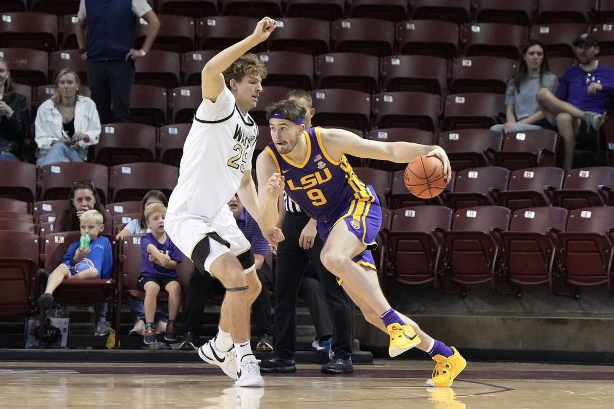 Nov 19, 2023; Charleston, SC, USA; LSU Tigers forward Will Baker (9) drives the ball around Wake Forest Demon Deacons forward Zach Keller (25) in the first half at TD Arena.