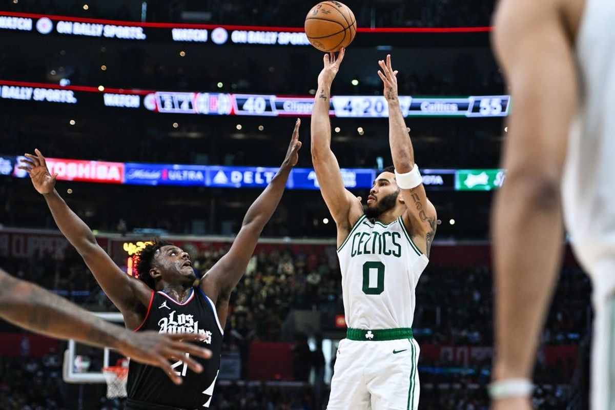 Dec 23, 2023; Los Angeles, California, USA; Boston Celtics forward Jayson Tatum (0) shoots against Los Angeles Clippers forward Kobe Brown (21) during the second quarter at Crypto.com Arena.