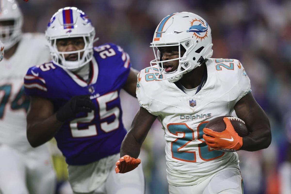 Jan 7, 2024; Miami Gardens, Florida, USA; Miami Dolphins running back De'Von Achane (28) runs with the football against the Buffalo Bills during the first quarter at Hard Rock Stadium.