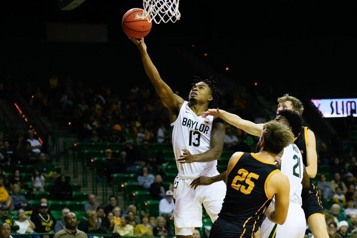 Nov 9, 2023; Waco, Texas, USA;  Baylor Bears guard Langston Love (13) scores a basket against John Brown Golden Eagles forward Lukas Gabani (25) during the second half at Ferrell Center.