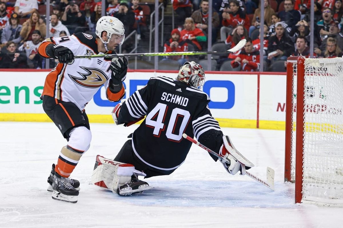 Dec 17, 2023; Newark, New Jersey, USA; Anaheim Ducks center Adam Henrique (14) scores a goal past New Jersey Devils goaltender Akira Schmid (40) during the second period at Prudential Center.