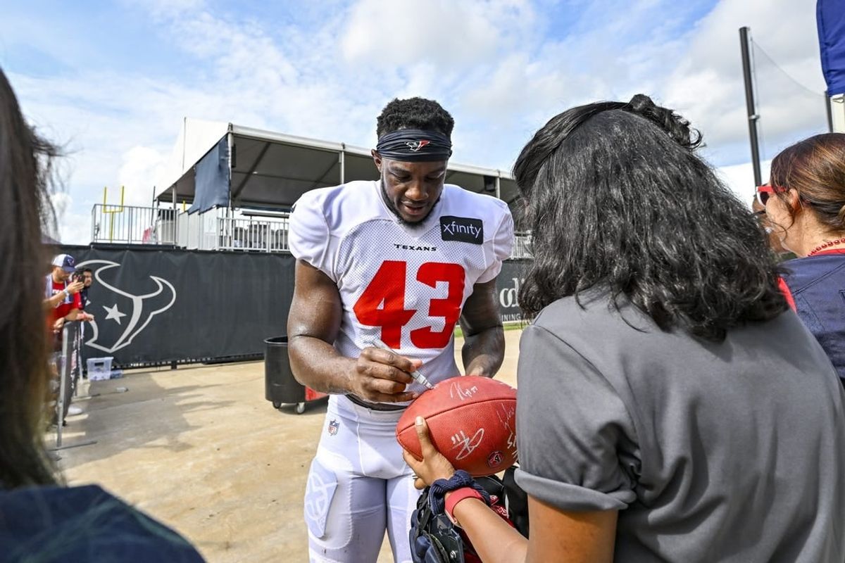 Aug 5, 2022; Houston, Texas, US; Houston Texans linebacker Neville Hewitt (43) signs autographs after training camp at the Texans practice facility.