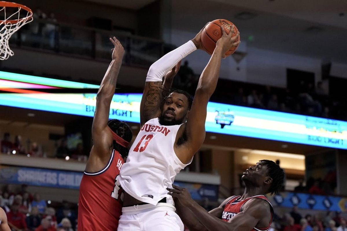 Nov 19, 2023; Charleston, SC, USA; Houston Cougars forward J'Wan Roberts (13) gets a rebound in the first half against the Dayton Flyers at TD Arena.