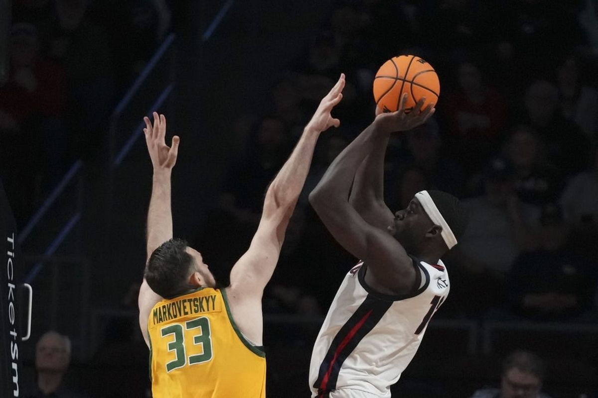 March 11, 2024; Las Vegas, NV, USA; Gonzaga Bulldogs forward Graham Ike (13) shoots the basketball against San Francisco Dons center Volodymyr Markovetskyy (33) during the first half in the semifinals of the WCC Basketball Championship at Orleans Arena.