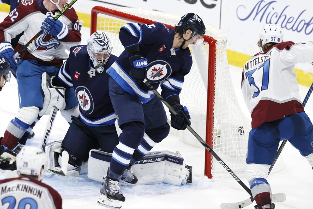 Apr 21, 2024; Winnipeg, Manitoba, CAN; Colorado Avalanche center Casey Mittelstadt (37) scores on Winnipeg Jets goaltender Connor Hellebuyck (37) in the third period in game one of the first round of the 2024 Stanley Cup Playoffs at Canada Life Centre.