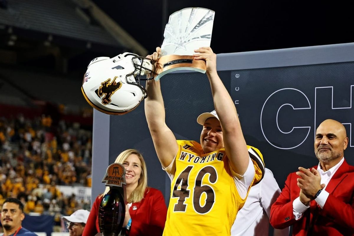 Dec 30, 2023; Tucson, AZ, USA; Wyoming Cowboys place kicker John Hoyland (46) celebrates with offensive MVP trophy after the Wyoming Cowboys beat the Toledo Rockets in the Arizona Bowl at Arizona Stadium.