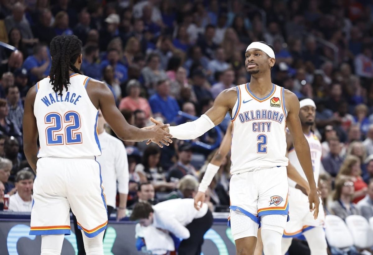 Apr 12, 2024; Oklahoma City, Oklahoma, USA; Oklahoma City Thunder guard Shai Gilgeous-Alexander (2) and guard Cason Wallace (22) high five during the second quarter against the Milwaukee Bucks at Paycom Center.