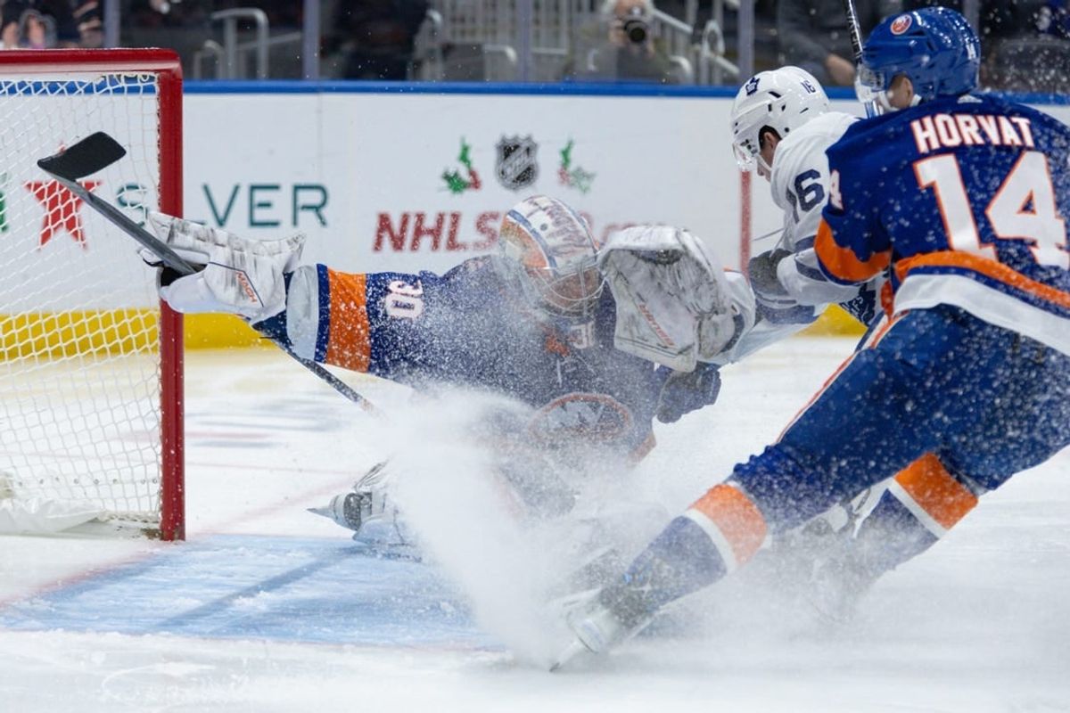 Dec 11, 2023; Elmont, New York, USA; New York Islanders goaltender Ilya Sorokin (30) makes a save after Toronto Maple Leafs right wing Mitchell Marner (16) takes a shot during the first period at UBS Arena.