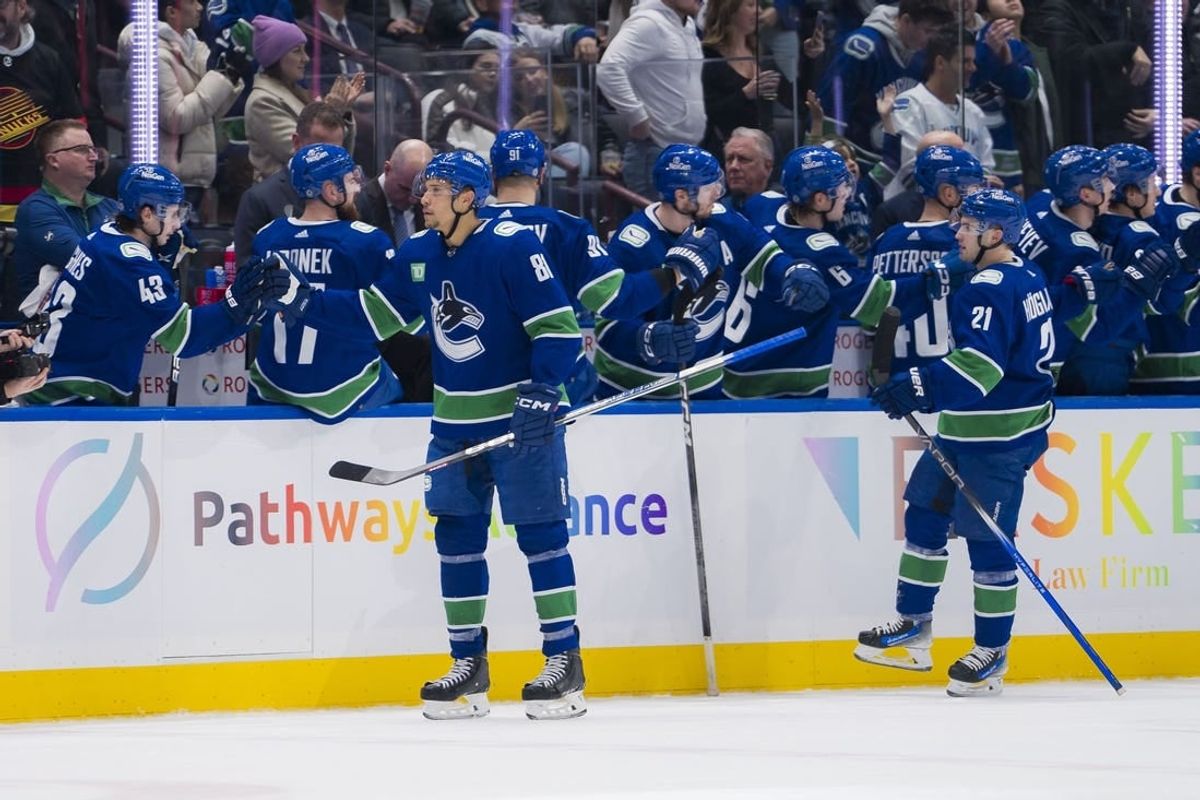 Jan 18, 2024; Vancouver, British Columbia, CAN; Vancouver Canucks forward Dakota Joshua (81) and forward Nils Hoglander (21) celebrate Joshua   s goal against the Arizona Coyotes in the second period at Rogers Arena.