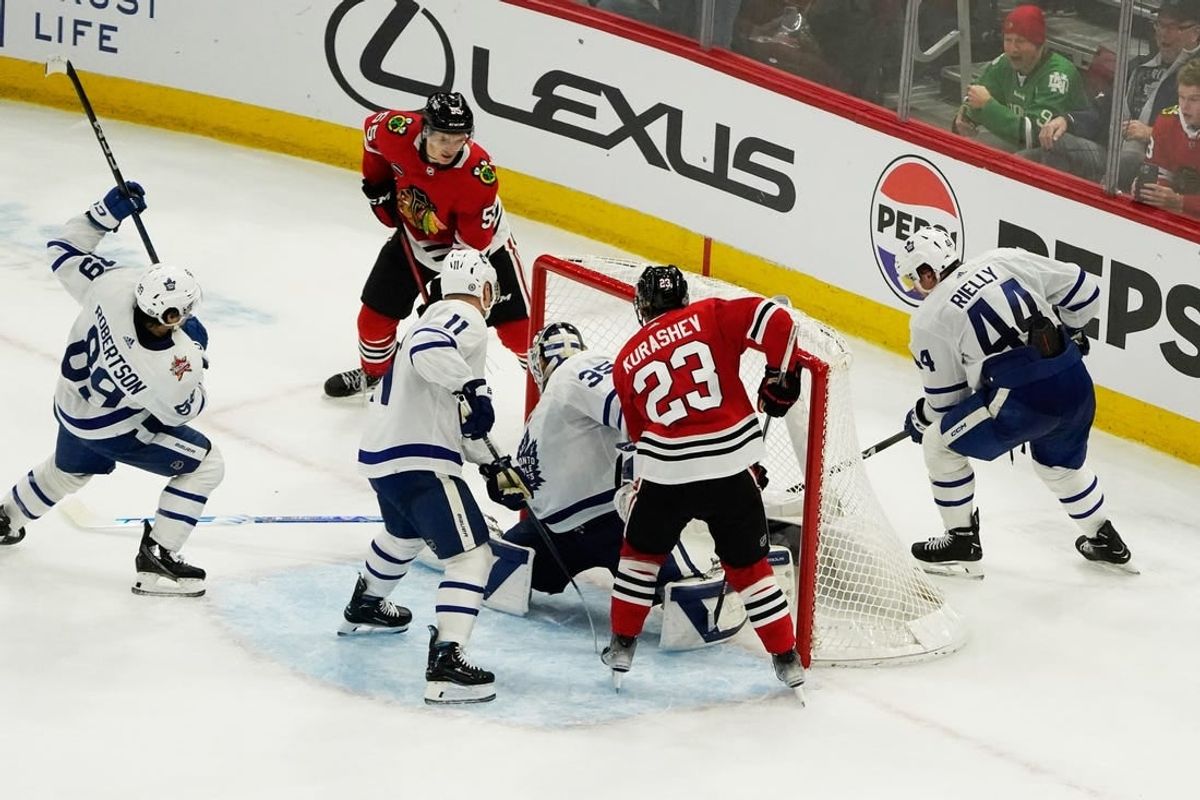 Nov 24, 2023; Chicago, Illinois, USA; Chicago Blackhawks defenseman Kevin Korchinski (55) scores the game winning goal during an overtime period against the Toronto Maple Leafs at United Center.