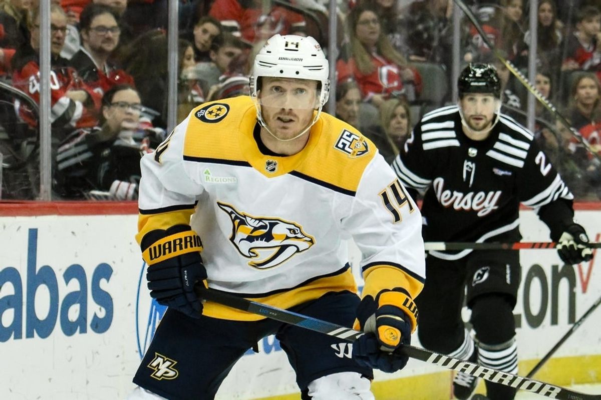 Apr 7, 2024; Newark, New Jersey, USA;  Nashville Predators center Gustav Nyquist (14) skates past New Jersey Devils defenseman Brendan Smith (2)during the third period at Prudential Center.