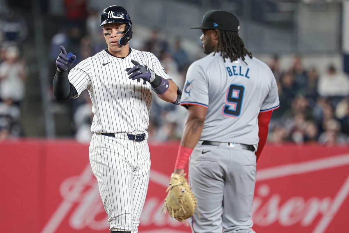 Apr 9, 2024; Bronx, New York, USA; New York Yankees center fielder Aaron Judge (99) reacts after a double during the third inning in front of Miami Marlins first baseman Josh Bell (9) at Yankee Stadium.