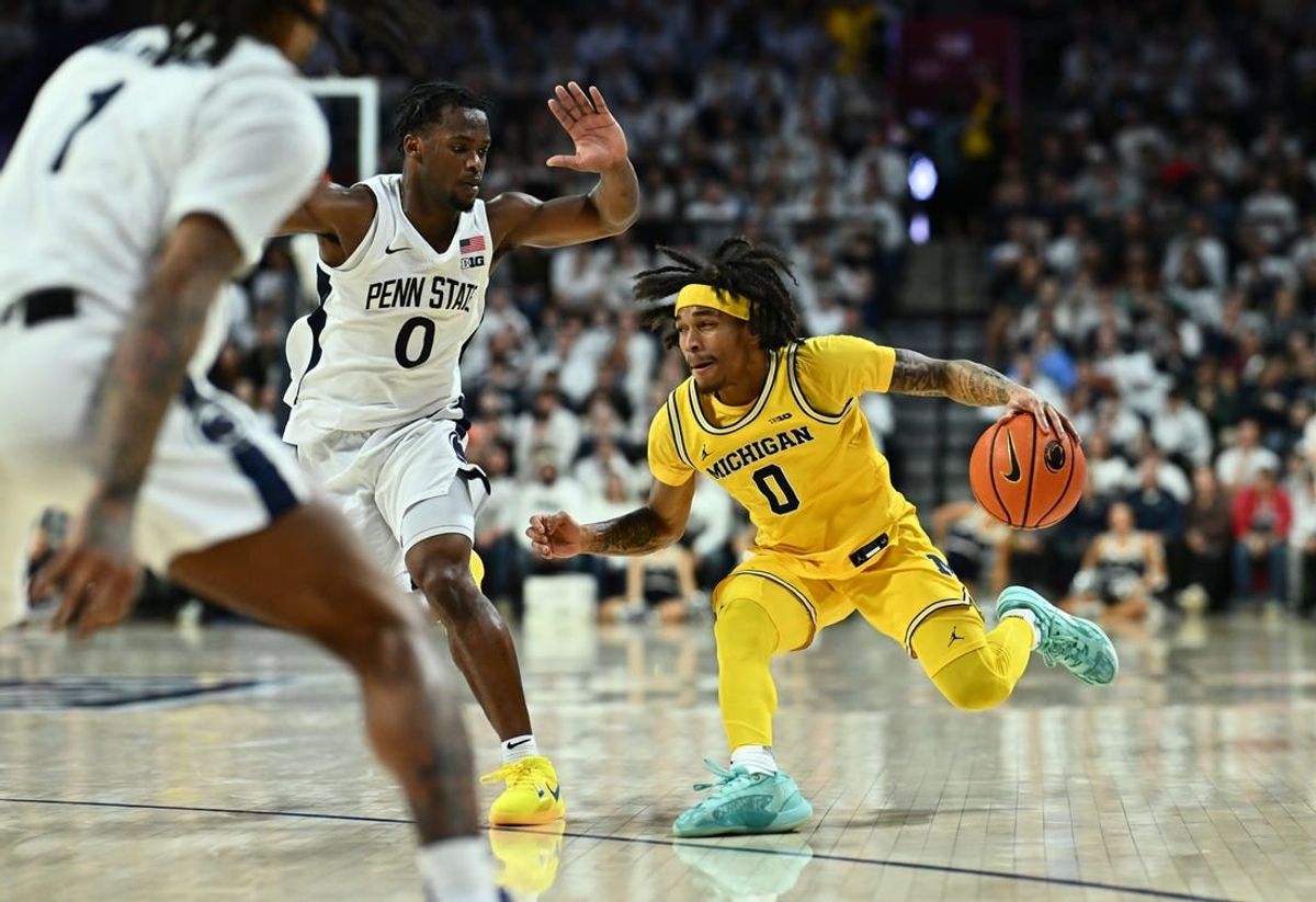 Jan 7, 2024; Philadelphia, Pennsylvania, USA; Michigan Wolverines guard Dug McDaniel (0) drives against Penn State Nittany Lions guard Kanye Clary (0) in the second half at The Palestra.
