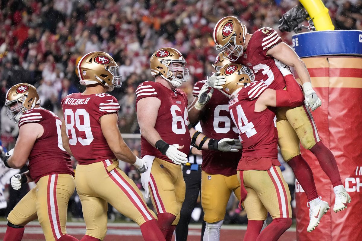 SANTA CLARA, CALIFORNIA - JANUARY 20: Christian McCaffrey #23 of the San Francisco 49ers celebrates with teammates after scoring a 6-yard rushing touchdown during the fourth quarter against the Green Bay Packers in the NFC Divisional Playoffs at Levi's Stadium on January 20, 2024 in Santa Clara, California. (Photo by Thearon W. Henderson/Getty Images)