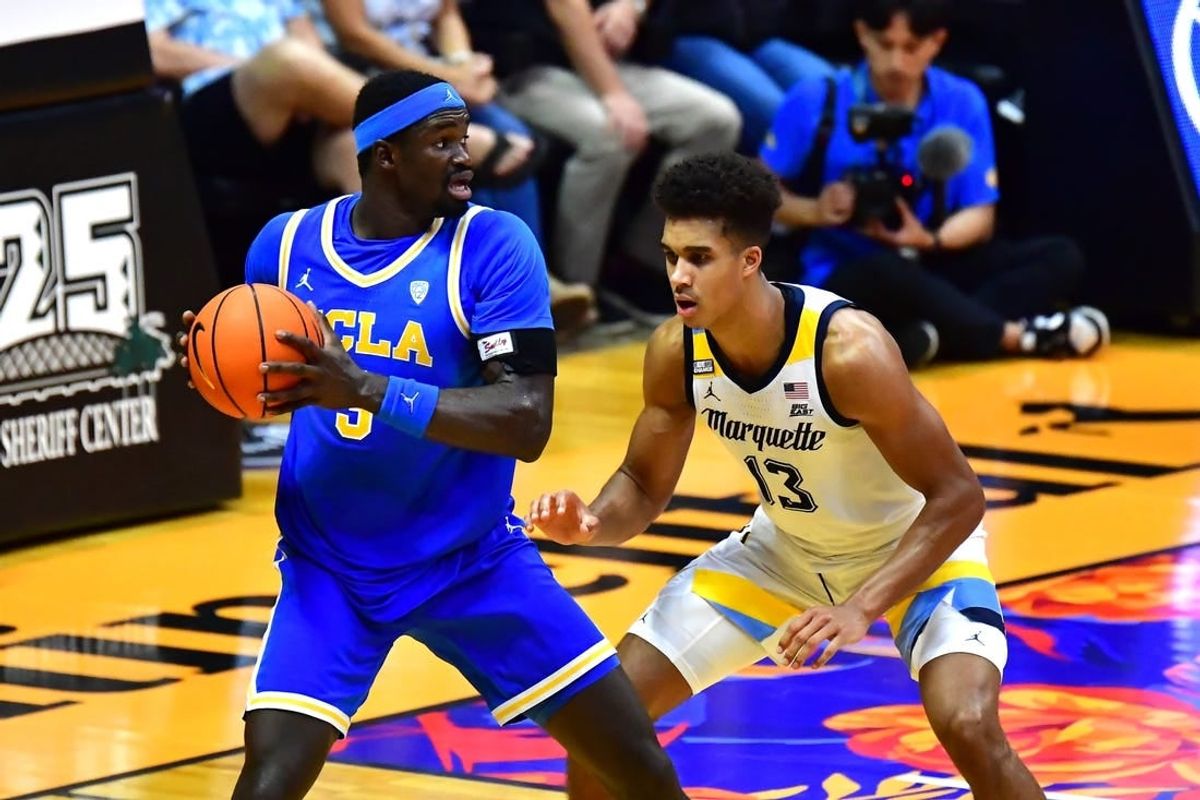 Nov 20, 2023; Honolulu, Hawaii, USA;  UCLA Bruins forward Adem Bona (3) is defended by Marquette Golden Eagles forward Oso Ighodaro (13) during the second period at SimpliFi Arena at Stan Sheriff Center.