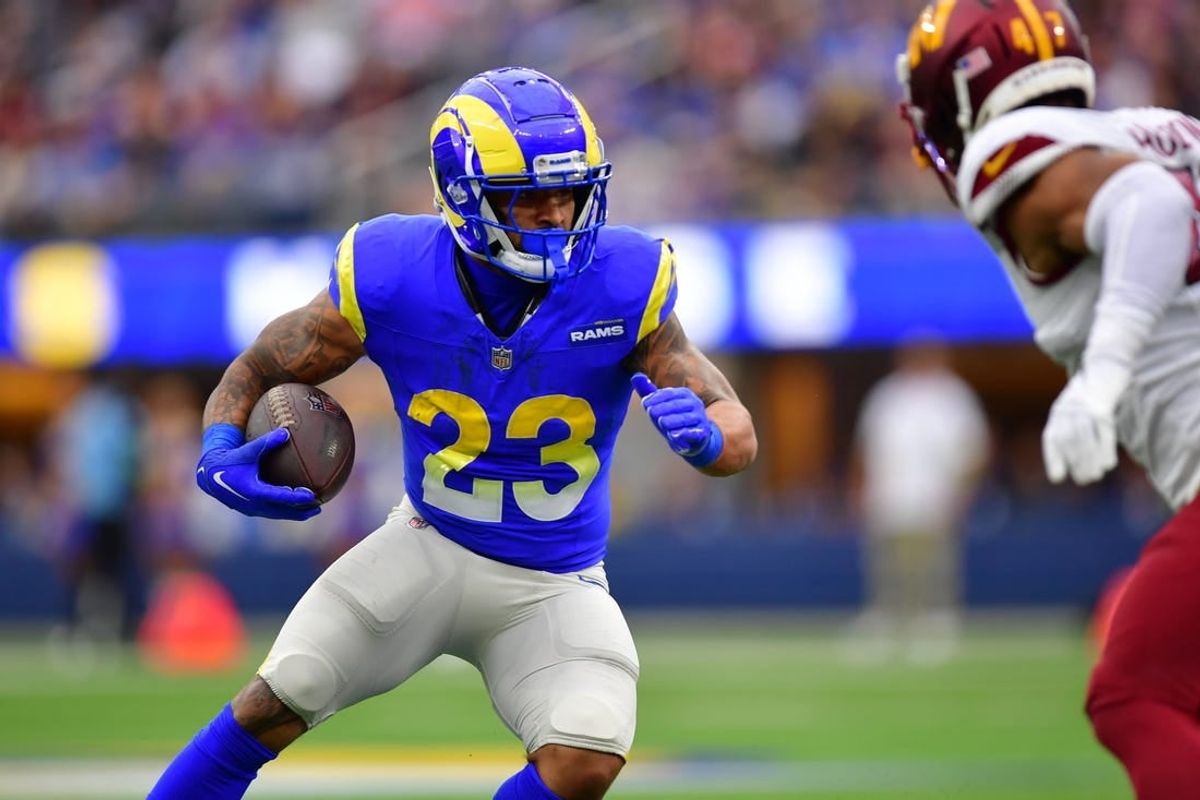 Dec 17, 2023; Inglewood, California, USA; Los Angeles Rams running back Kyren Williams (23) runs the ball against Washington Commanders linebacker Khaleke Hudson (47) during the first half at SoFi Stadium.
