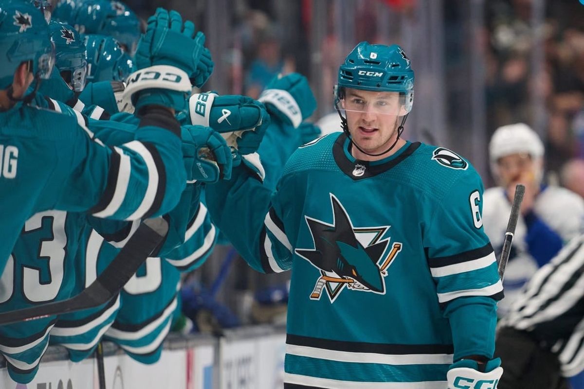 Nov 25, 2023; San Jose, California, USA; San Jose Sharks defenseman Ty Emberson (6) shakes hands with his teammates after scoring a goal against the Vancouver Canucks during the first period at SAP Center at San Jose.