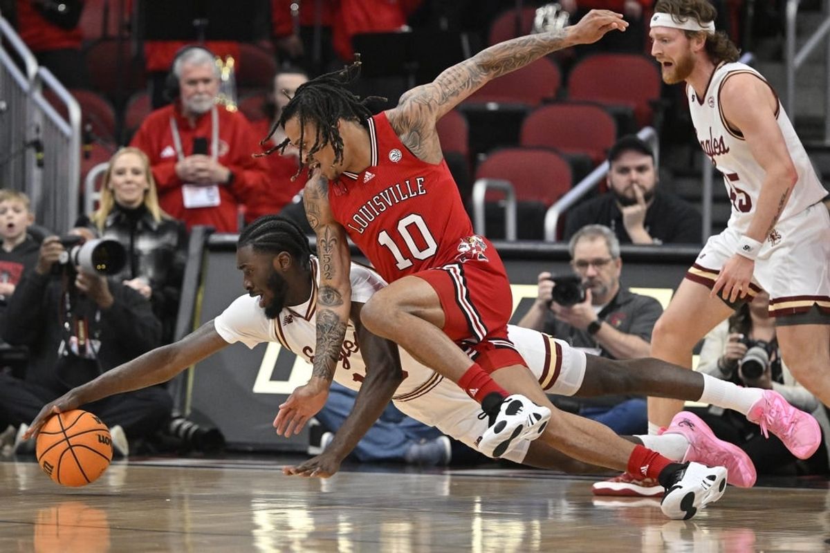 Mar 9, 2024; Louisville, Kentucky, USA;  Boston College Eagles guard Prince Aligbe (10) dives for the ball with Louisville Cardinals forward Kaleb Glenn (10) during the first half at KFC Yum! Center.