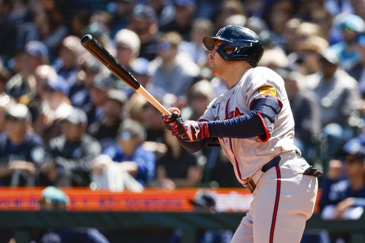 May 1, 2024; Seattle, Washington, USA; Atlanta Braves third baseman Austin Riley (27) hits a two-run triple against the Seattle Mariners during the fourth inning at T-Mobile Park.