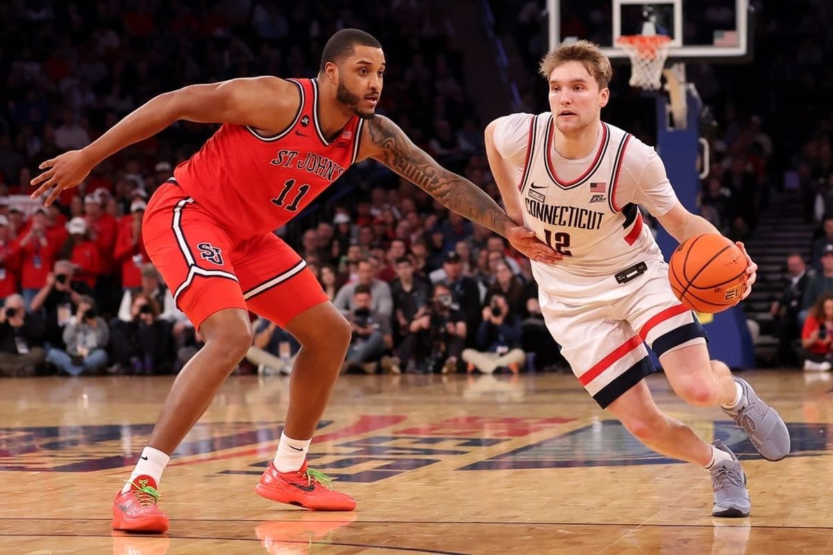 Mar 15, 2024; New York City, NY, USA; Connecticut Huskies guard Cam Spencer (12) drives to the basket against St. John's Red Storm center Joel Soriano (11) during the second half at Madison Square Garden.