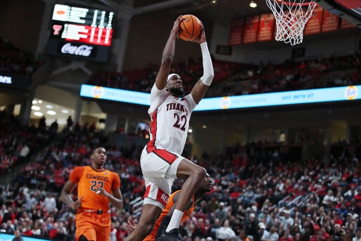 Jan 9, 2024; Lubbock, Texas, USA; Texas Tech Red Raiders forward Warren Washington (22) goes to the basket against Oklahoma State Cowboys center Brandon Garrison (23) in the first half at United Supermarkets Arena.