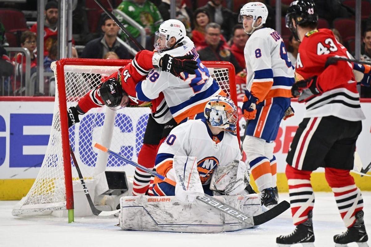 Jan 19, 2024; Chicago, Illinois, USA;  New York Islanders defenseman Alexander Romanov (28) collides with Chicago Blackhawks forward Jason Dickinson (16) behind goaltender Ilya Sorokin (30) in the first period at United Center.