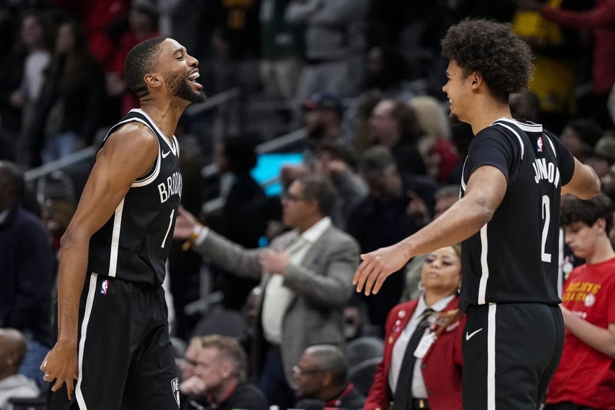 Dec 6, 2023; Atlanta, Georgia, USA; Brooklyn Nets forward Mikal Bridges (1) reacts with forward Cameron Johnson (2) after the Nets defeated the Atlanta Hawks at State Farm Arena.